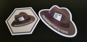  Two stickers: one hexagon sticker with a brown hat, and the other a brown hat.